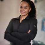 Leya Mnangagwa smiling in athletic wear, reflecting strength, confidence, and commitment to a holistic wellness journey