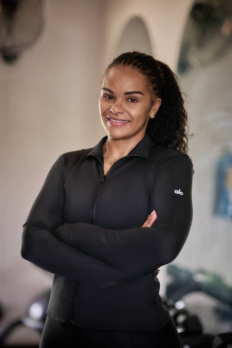 Leya Mnangagwa smiling in athletic wear, reflecting strength, confidence, and commitment to a holistic wellness journey