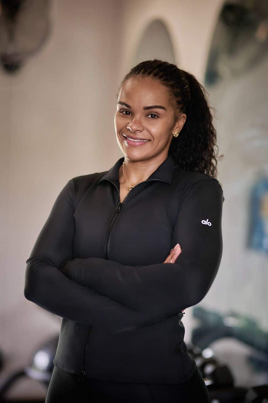 Leya Mnangagwa smiling in athletic wear, reflecting strength, confidence, and commitment to a holistic wellness journey