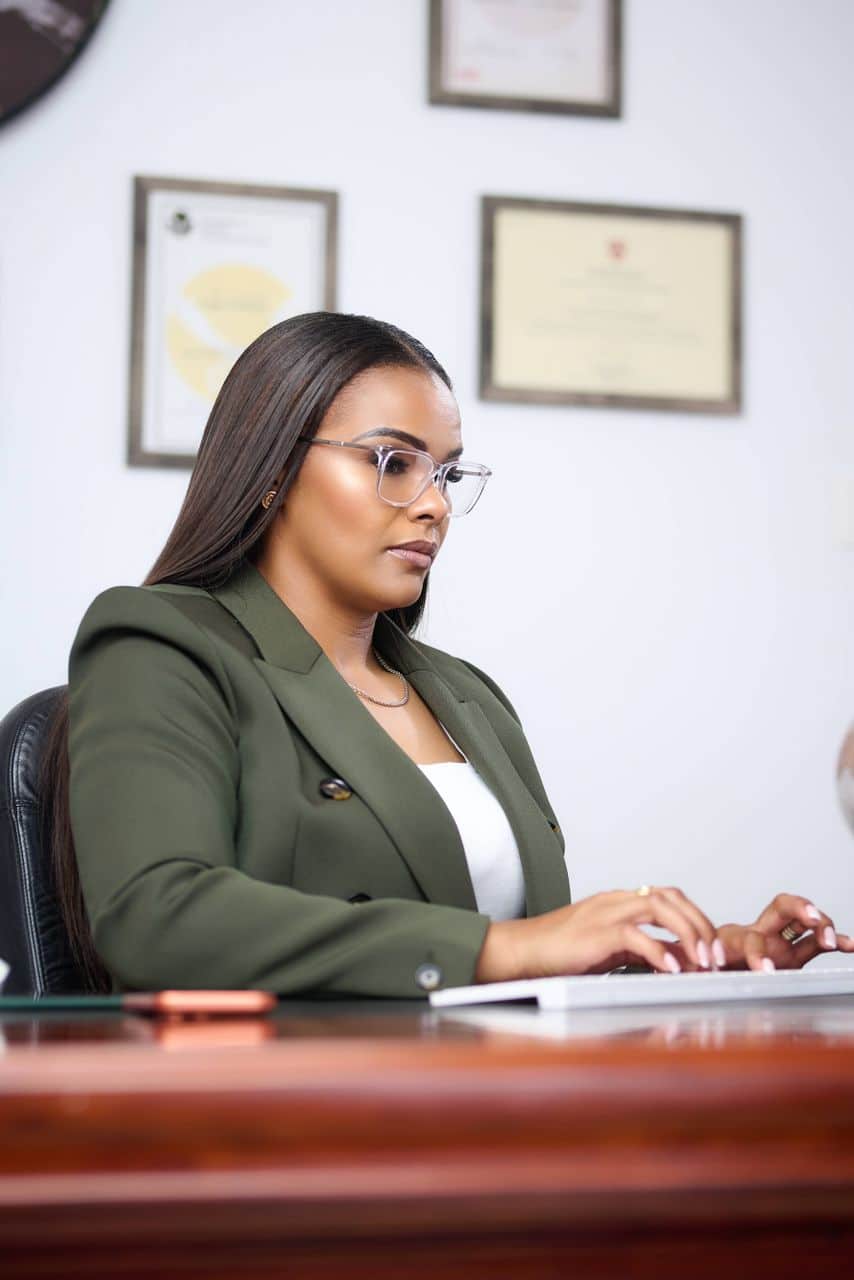 Leya Mnangagwa working at her desk reflecting on balance and the four burner theory