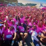 Hundreds of women celebrating together at the Her Miles Women's Run, a powerful moment of women's wellness community in Zimbabwe